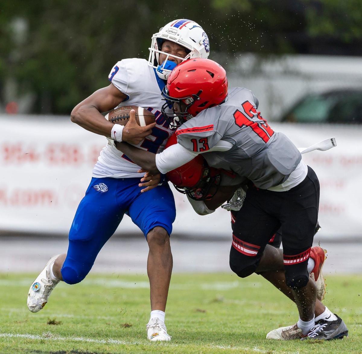 Monarch Knights defensive back Jeremy Daniels (13) tries to tackle Peachtree Ridge Lions wide receiver Kobe Hokes (3) in the first half of their football game at Coconut Creek High School on Thursday, Aug. 22, 2024, in Coconut Creek, Fla.