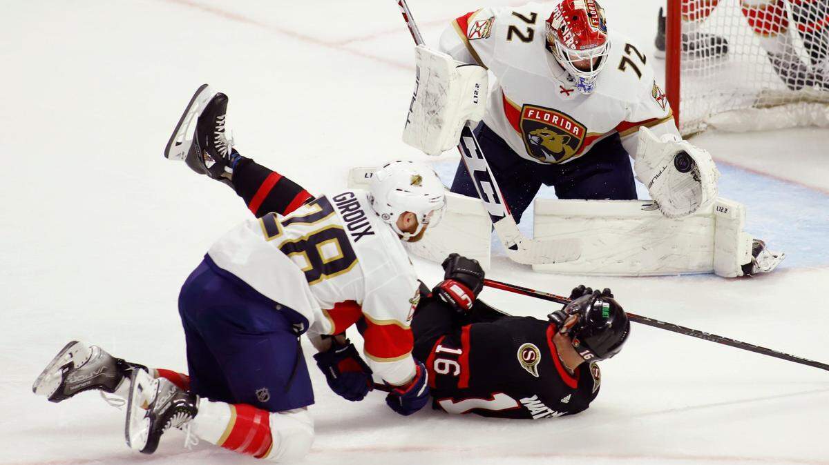 Florida Panthers goaltender Sergei Bobrovsky (72) makes a save as Ottawa Senators’ Austin Watson (16) and Panthers’ Claude Giroux (28) fall during the second period of an NHL hockey game Saturday, March 26, 2022, in Ottawa, Ontario. (Patrick Doyle/The Canadian Press via AP)