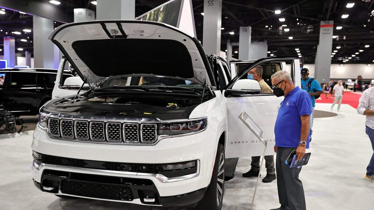 Car enthusiasts gather around a 2022 Jeep Grand Wagoneer at the Miami International Auto Show in the Miami Beach Convention Center on Sunday, October 17, 2021.