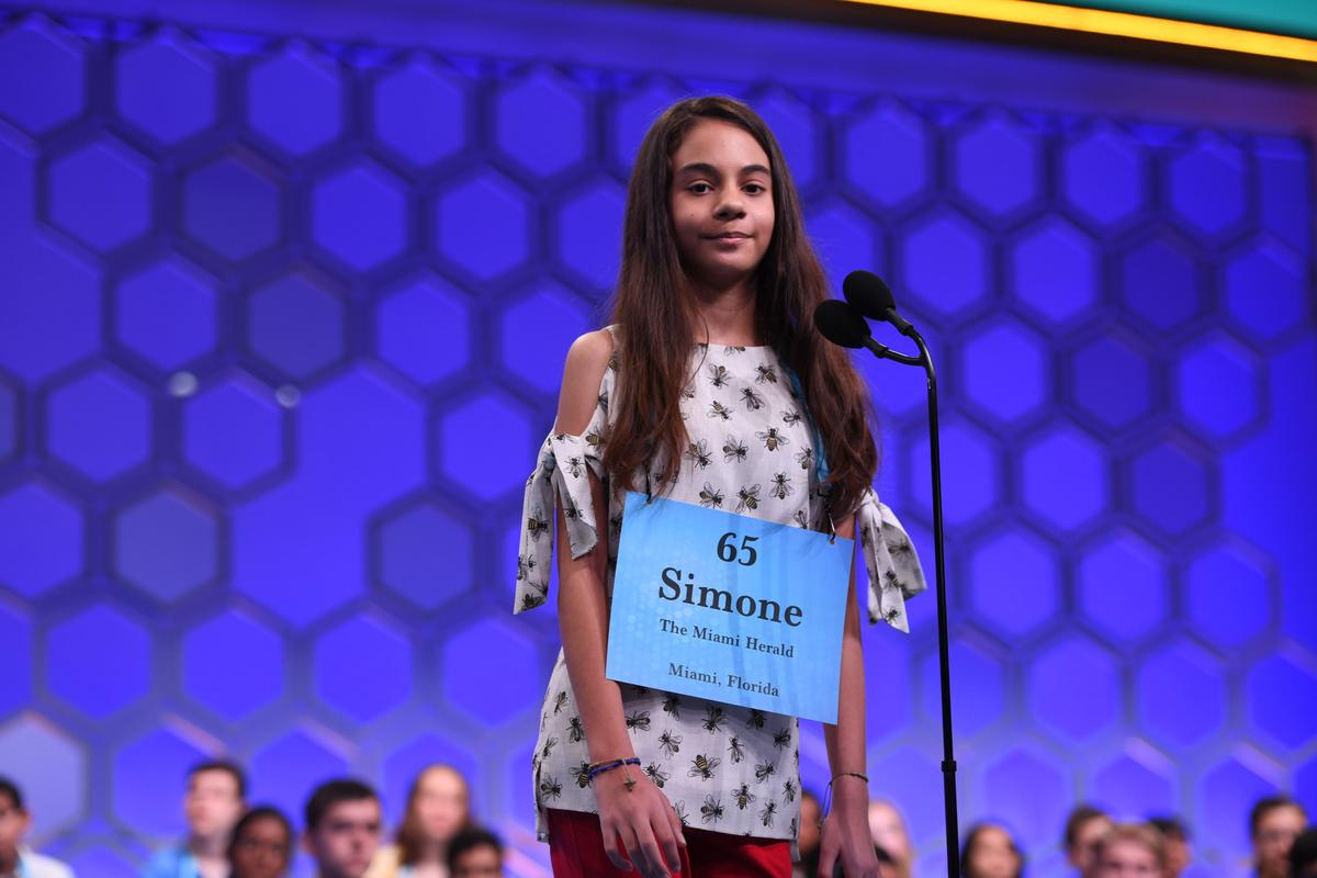Simone Kaplan, 13, a seventh-grader at St. Bonaventure Catholic School in Davie, spells her word correctly in Thursday’s first part of the final round in the Scripps National Spelling Bee in National Harbor, Maryland. She is one of 16 finalists who will appear in the final round, which will begin at 8:30 p.m. and be broadcast on ESPN.