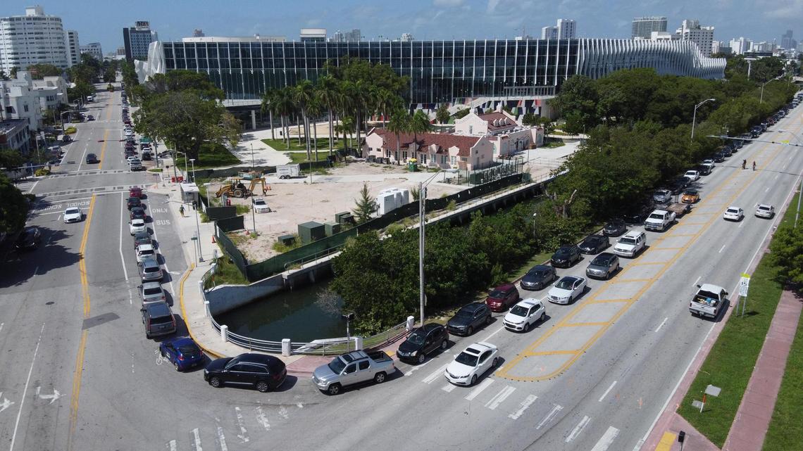 A long line of cars waiting to enter the COVID-19 drive-through testing site wraps around the Miami Beach Convention Center at the intersection of Dade blvd and Washington Ave Thursday morning around 11am.