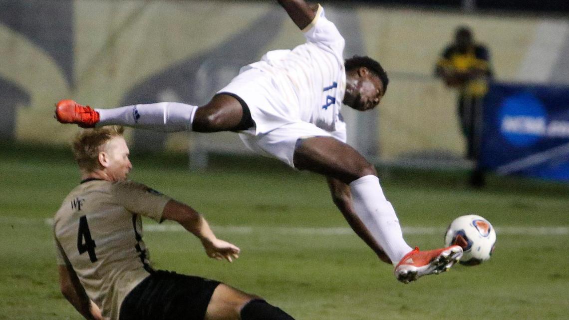 FIU forward Stephen Afrifa jumps over Wake Forest’s Holland Rula during the NCAA District 1 Men’s Soccer tournament Sunday at FIU.