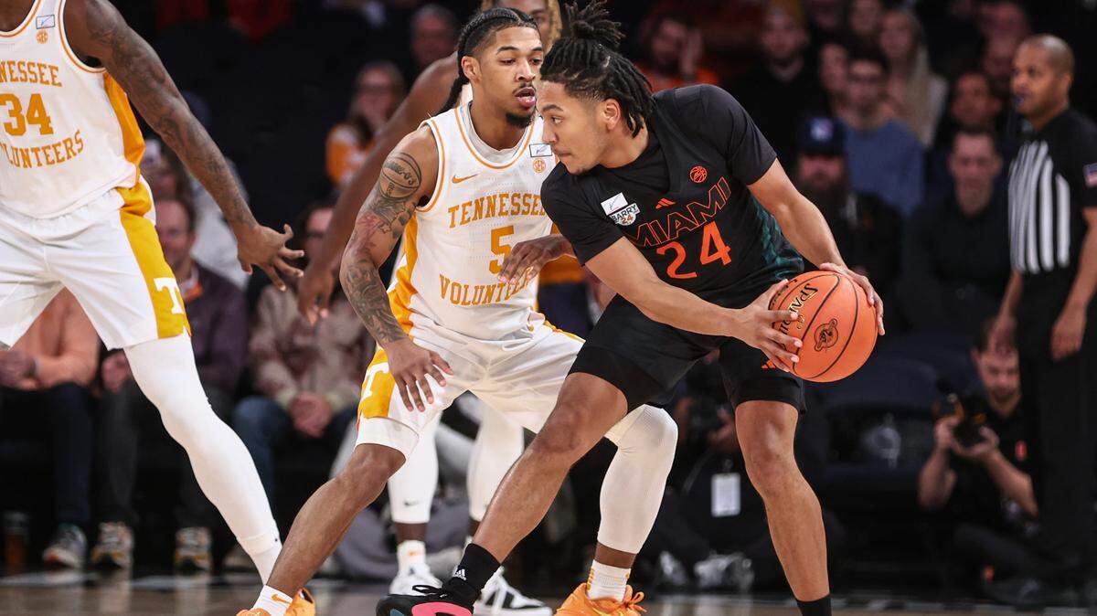 Dec 10, 2024; New York, New York, USA; Miami Hurricanes guard Nijel Pack (24) looks to drive past Tennessee Volunteers guard Zakai Zeigler (5) in the first half at Madison Square Garden. Mandatory Credit: Wendell Cruz-Imagn Images