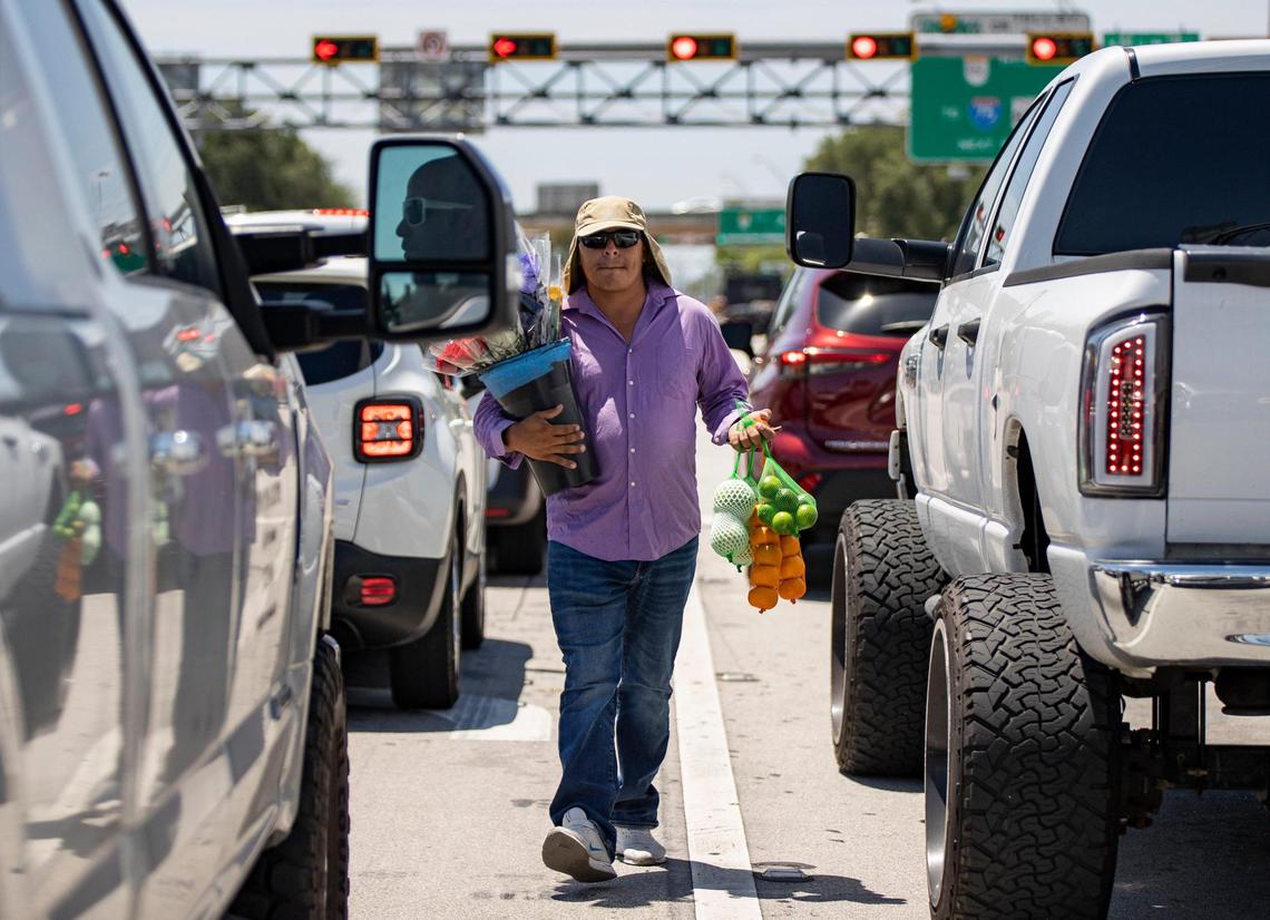 Street vendor Eddy Rivera sells fruits and flowers near the intersection of Red Road and West 84th St in Hialeah.