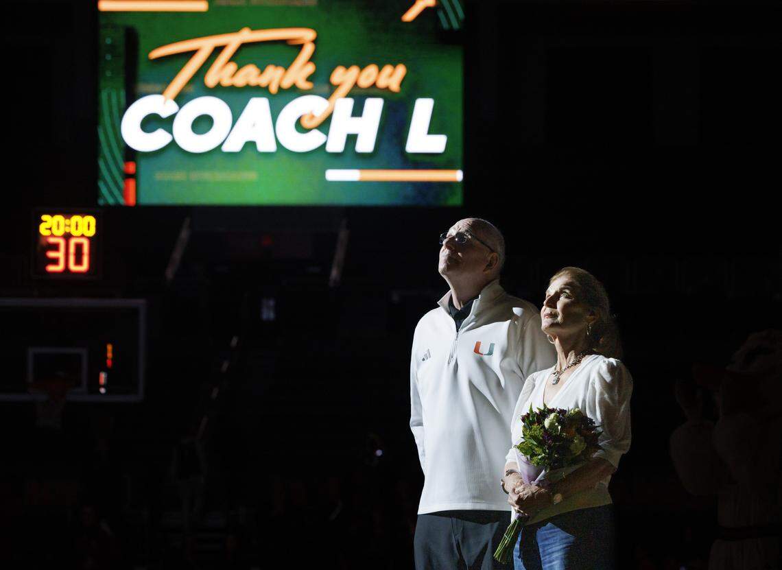 Former Head Coach Jim Larrañaga, left, stands on the court with his wife during a ceremony raising a banner in his honor during the first half of the game on Tuesday, Jan. 20, 2026, at Watsco Center in Coral Gables, Fla.