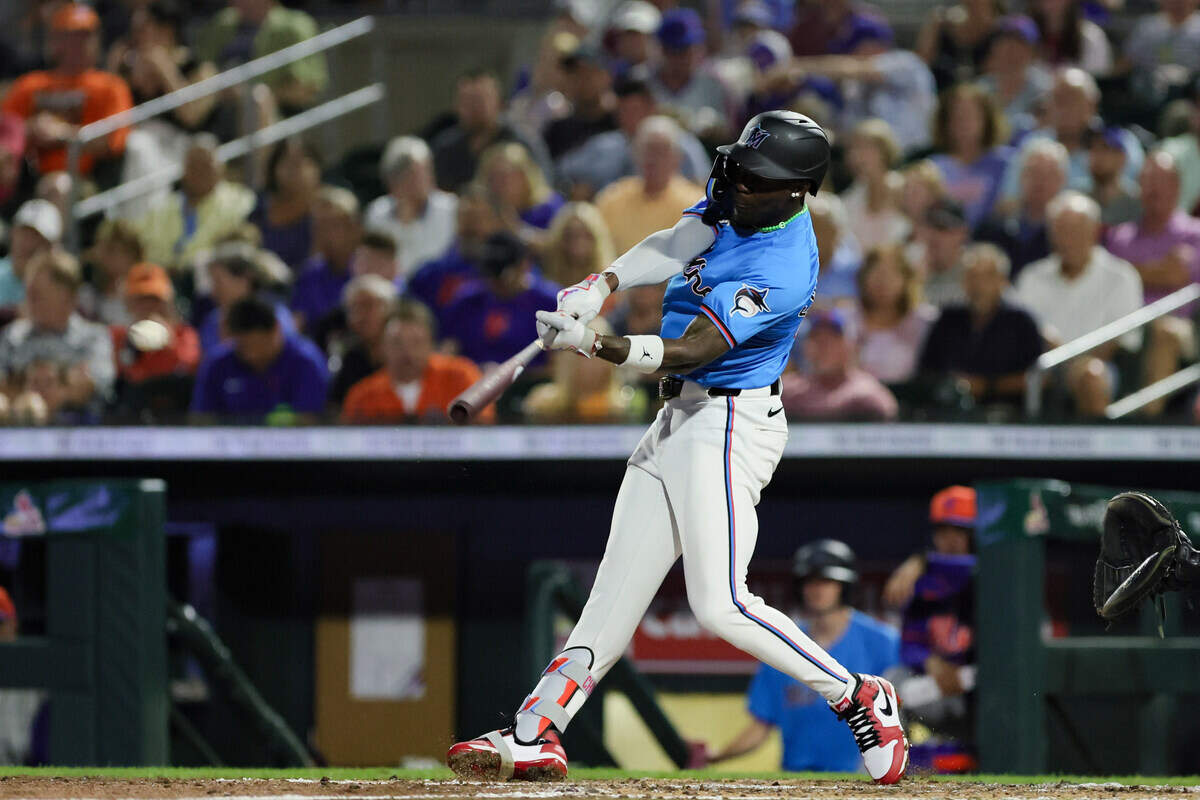 Mar 8, 2024; Jupiter, Florida, USA; Miami Marlins center fielder Jazz Chisholm Jr.(2) hits a single against the New York Mets during the fourth inning at Roger Dean Chevrolet Stadium.
