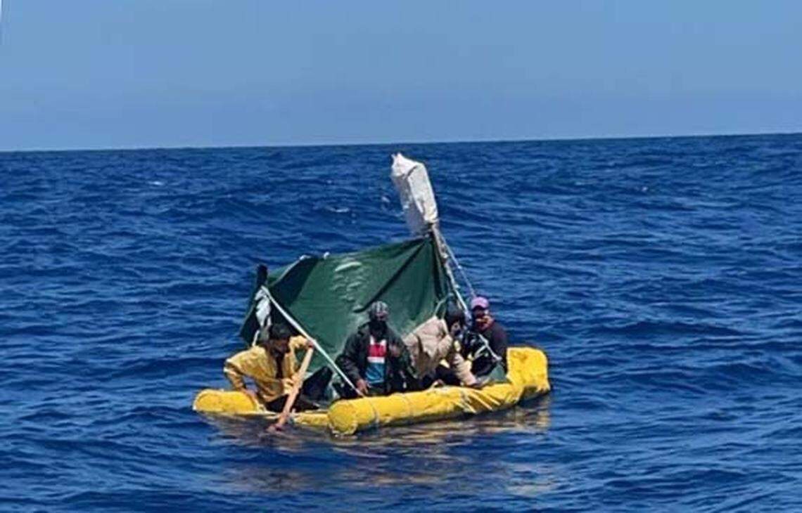A yellow raft with several Cuban migrants on board floats in the ocean off Key West. The men were among 14 people taken back to Cuba by the Coast Guard Friday, April 1, 2022.