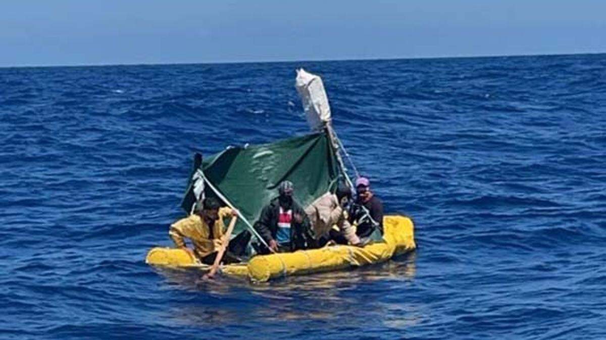 A yellow raft with several Cuban migrants on board floats in the ocean off Key West. The men were among 14 people taken back to Cuba by the Coast Guard on April 1. Three Cuban migrants made landfall in the Keys Friday, April 29, 2022.