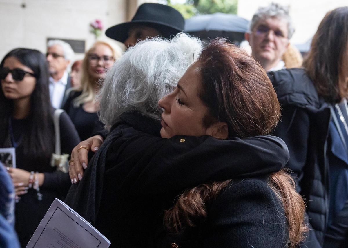 Joyce Moore, left, wife of the late Sam Moore, hugs Gloria Estefan during his funeral service at Lakeside Memorial Park and Funeral Home on Friday, Jan. 17, 2025, in Doral, Fla. Moore, the R&B singer from the famed 1960s duo Sam & Dave, died on Friday, Jan. 10, at the age of 89.