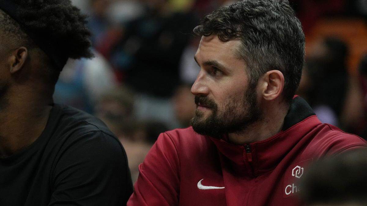 Miami Heat forward Kevin Love (42) sits on the bench as the clock winds down in the game against the Memphis Grizzlies at Miami-Dade Arena.