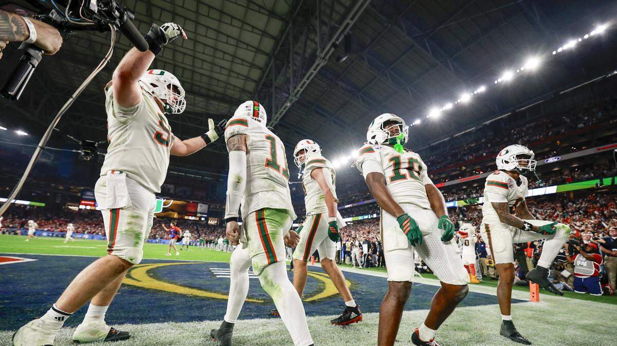 Miami Hurricanes quarterback Carson Beck (11) and teammates celebrate after scoring during the second half of a College Football Playoff semifinal against the Mississippi Rebels in the Fiesta Bowl at State Farm Stadium on Thursday, January 8, 2026 in Glendale, Arizona.