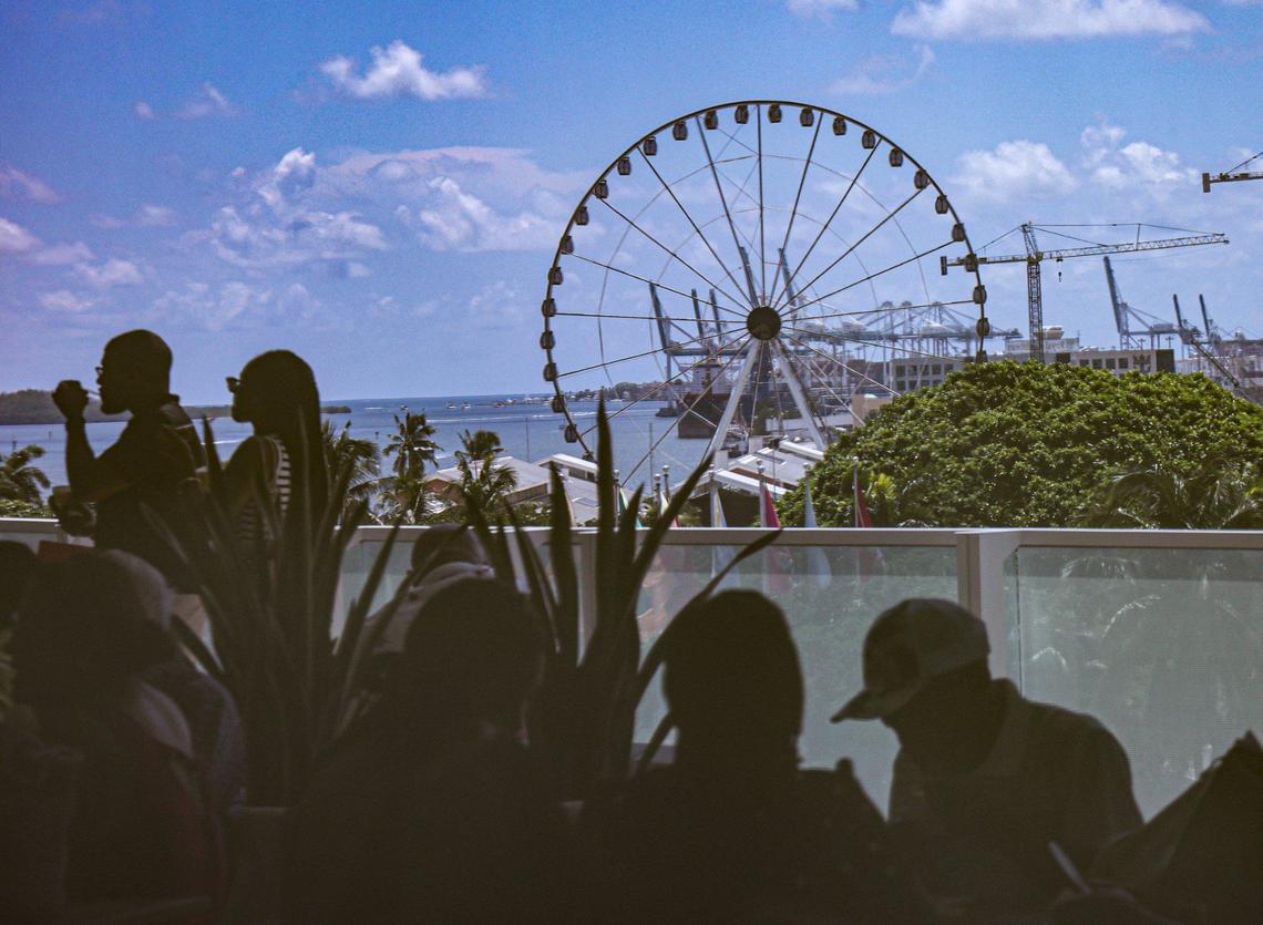 The reflection of congregants enjoying ice cream and refreshments and the view is cast on the glass door of the 7th-floor terrace. The church sold its old building in 2018 for $55 million and is now located in a luxury condo tower.
