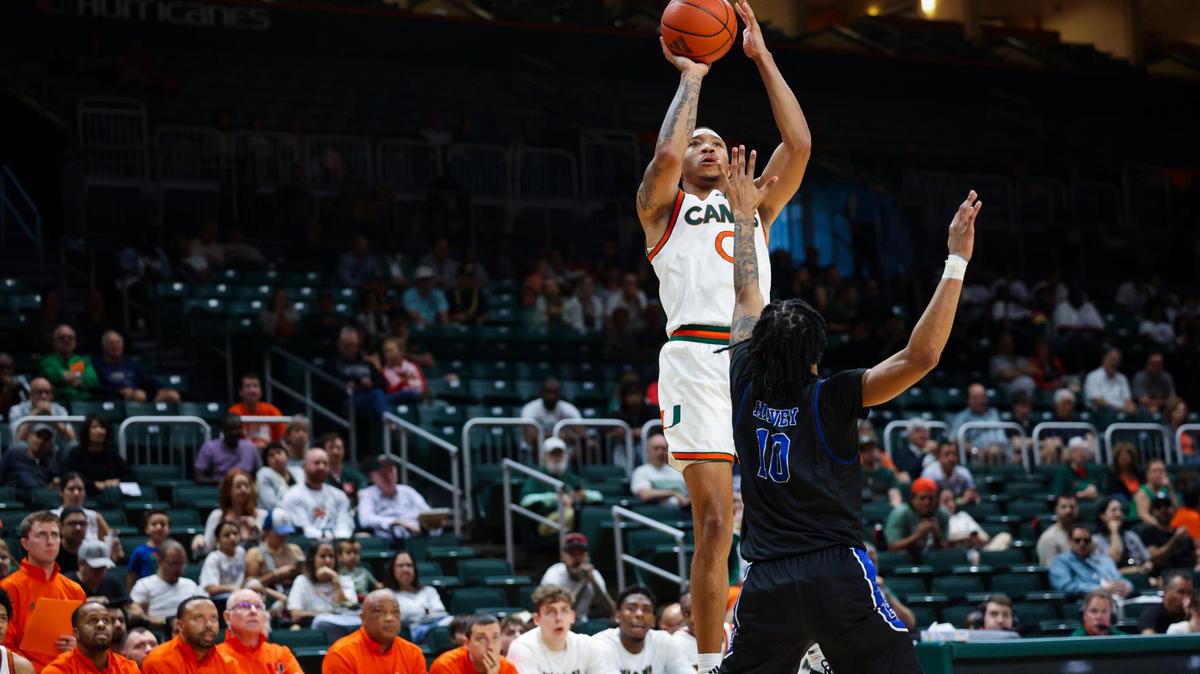Miami Hurricanes guard Matthew Cleveland (0) scores by shooting over Presbyterian Blue Hose guard Jamahri Harvey (10) during the second half of the game on Sunday, Dec. 15, 2024, at the Watsco Center in Coral Gables, Fla. The Hurricanes won.