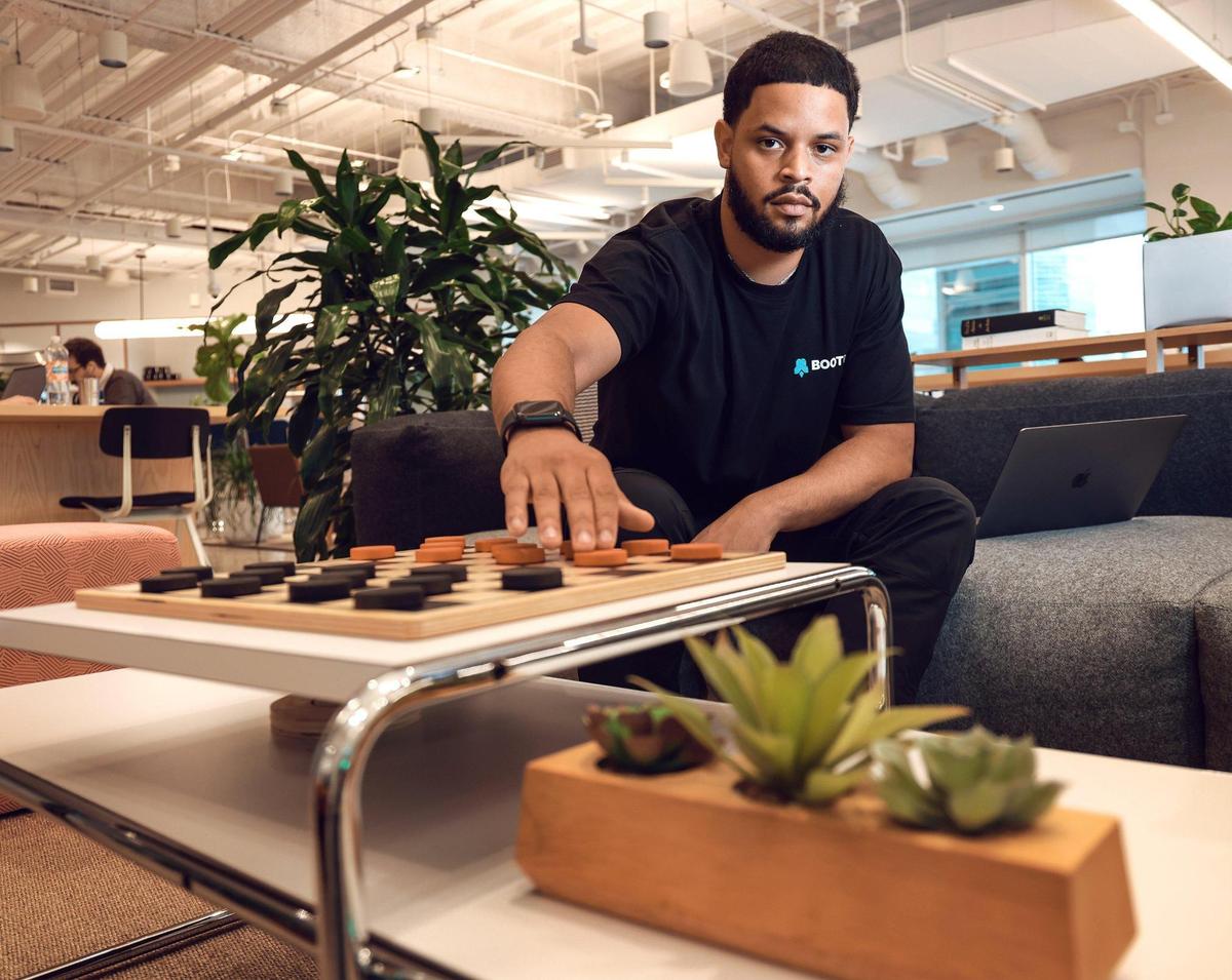 Chandler Malone, 27, the CEO of Boot Up whose company help diverse communities of bootcamps and vocational school graduates fill their hiring needs, is photographed at his shared office space in Miami, Florida on Wednesday, November 3, 2021.