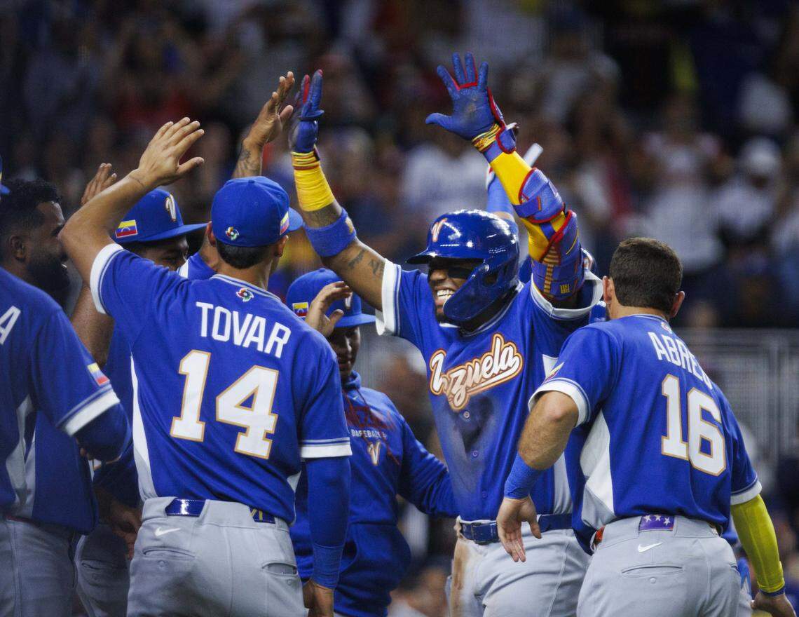 Venezuela outfielder Ronald Acuña Jr. (21) high-fives teammates after hitting a home run during the third inning of a World Baseball Classic game against the Nicaragua on Monday, March 9, 2026, at loanDepot Park in Miami, Fla.