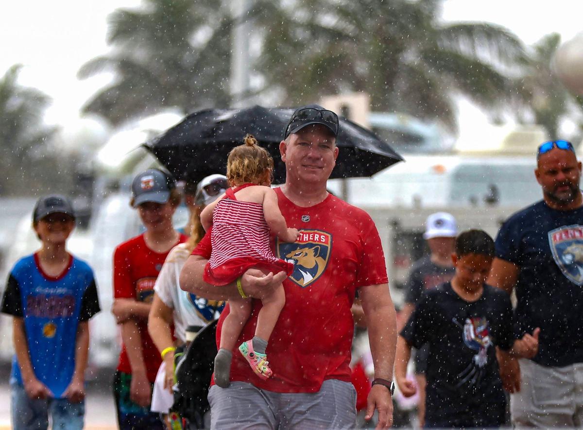 Panthers fans walk in the rain on A1A before the Stanley Cup Victory Parade at Fort Lauderdale Beach on Tuesday, June 30, 2024 in Fort Lauderdale.