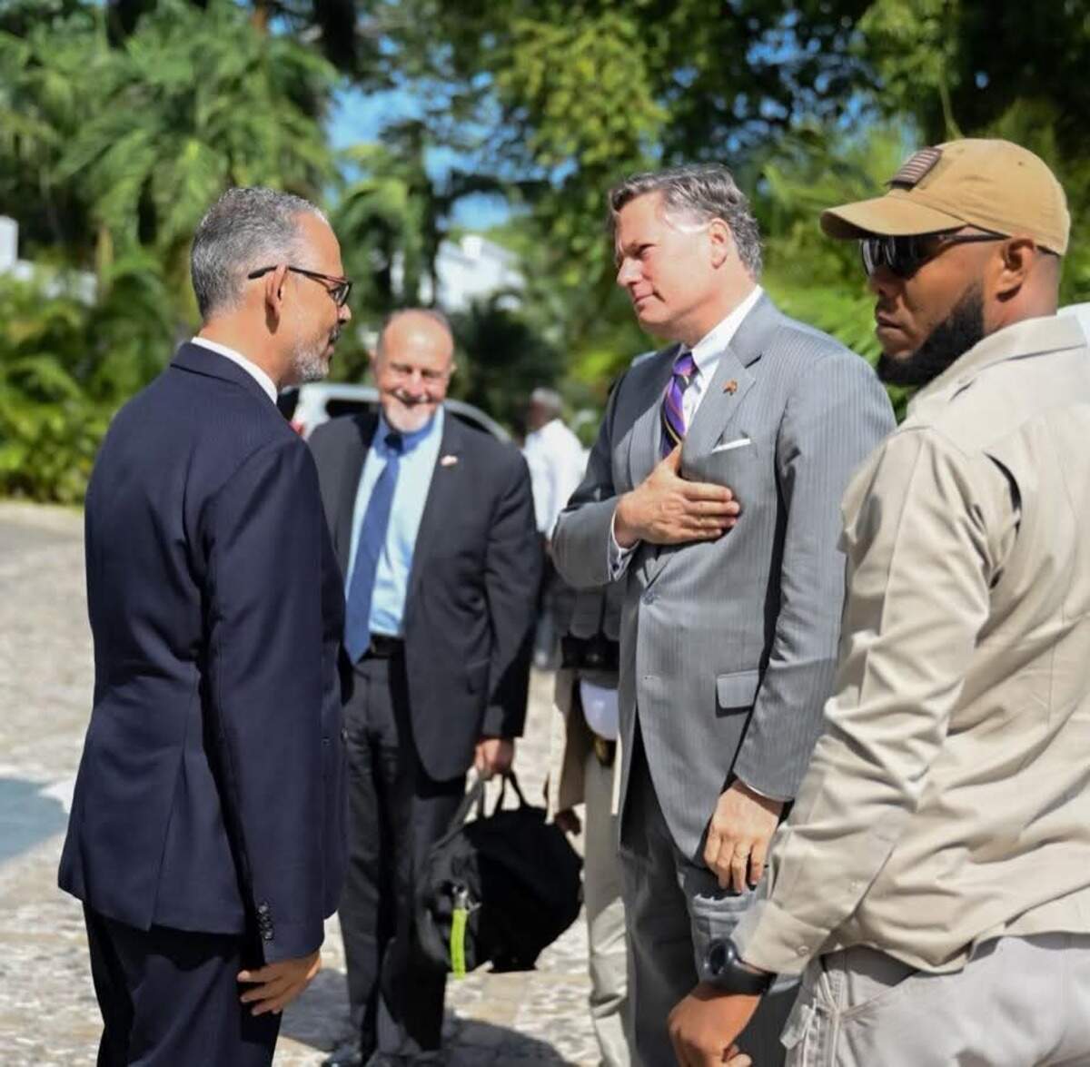 Haiti Prime Minister Alix Didier Fils-Aimé, left, speaks with U.S. Deputy Secretary of State Christopher Landau in Port-au-Prince on Friday, May 29, 2026. In the background is the U.S. chargé d’affaires in Haiti, Henry T. Wooster.