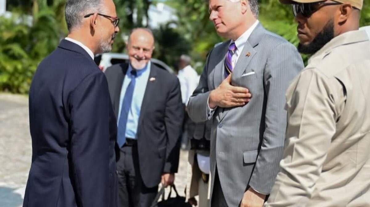 Haiti Prime Minister Alix Didier Fils-Aimé, left, speaks with U.S. Deputy Secretary of State Christopher Landau in Port-au-Prince on Friday, May 29, 2026. In the foreground is the U.S. chargé d’affaires in Haiti, Henry T. Wooster.