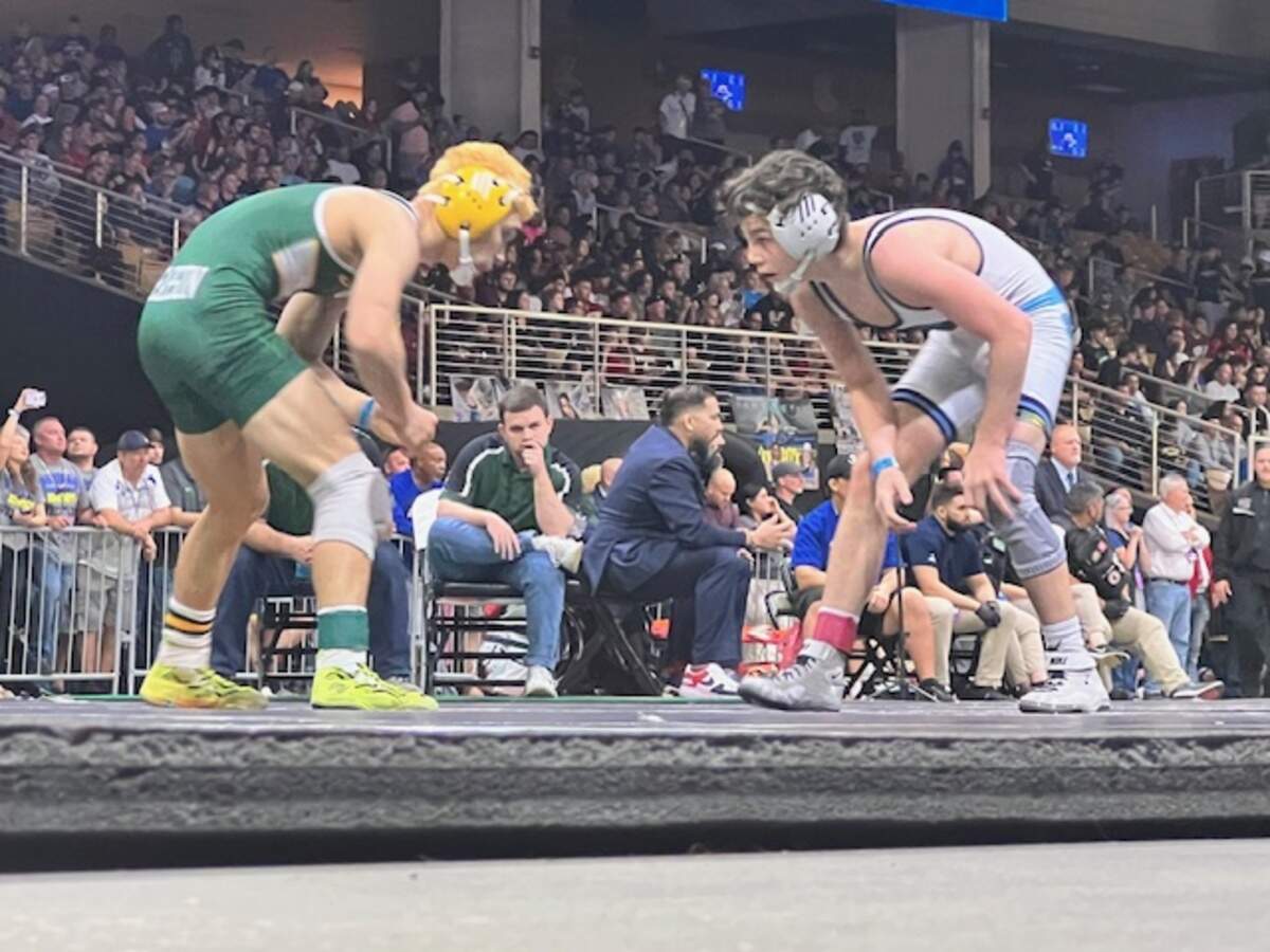 Somerset Academy’s Jake Austin stares down Suwanee’s Topher Pearson in the Class 1A 113-pound weight class state championship bout on Saturday in Kissimmee, Fla.