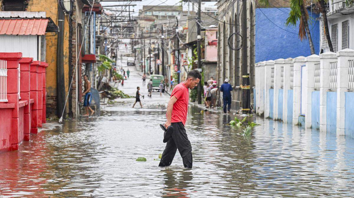 Cuba has dealt with several natural disaster in 2025. Here, a man walks through a flooded street in a neighborhood affected by Hurricane Melissa in Santiago de Cuba on Oct. 29, 2025.