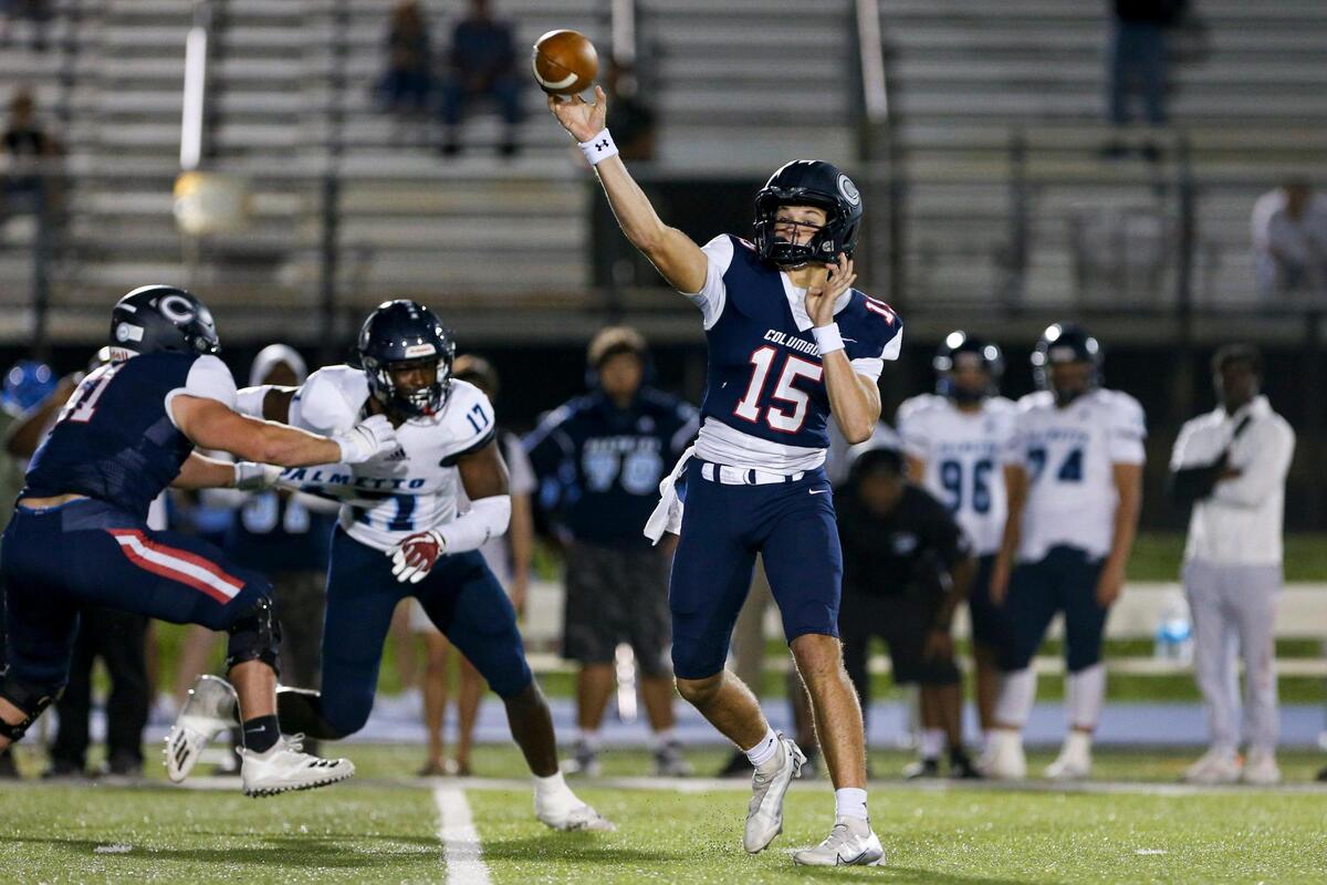 Columbus Explorers quarterback Alberto Mendoza (15) throws the football during the first quarter of a high school football playoff game against the Palmetto Panthers at Tropical Park in Miami, Florida, Friday, November 18, 2022.