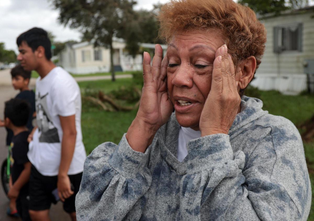 Bienvenida Rodriguez,71, recounts the sounds and force of the early morning tornado that damaged multiple homes in Sunshine Village. A tornado possibly spawned by Hurricane Ian caused downed trees, traffic lights, and damage to property in and around Sunshine Village, a mobile home park in Davie, Florida on Wednesday, September 28, 2022.
