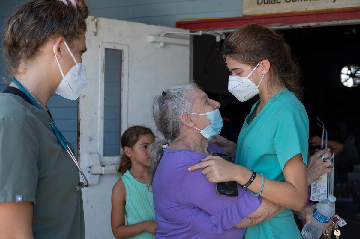 Third Wave Volunteers intern Adriana Olea comforts a Dulac, Louisiana resident during COVID testing and emergency response after Hurricane Ida. Photo provided by Third Wave Volunteers
