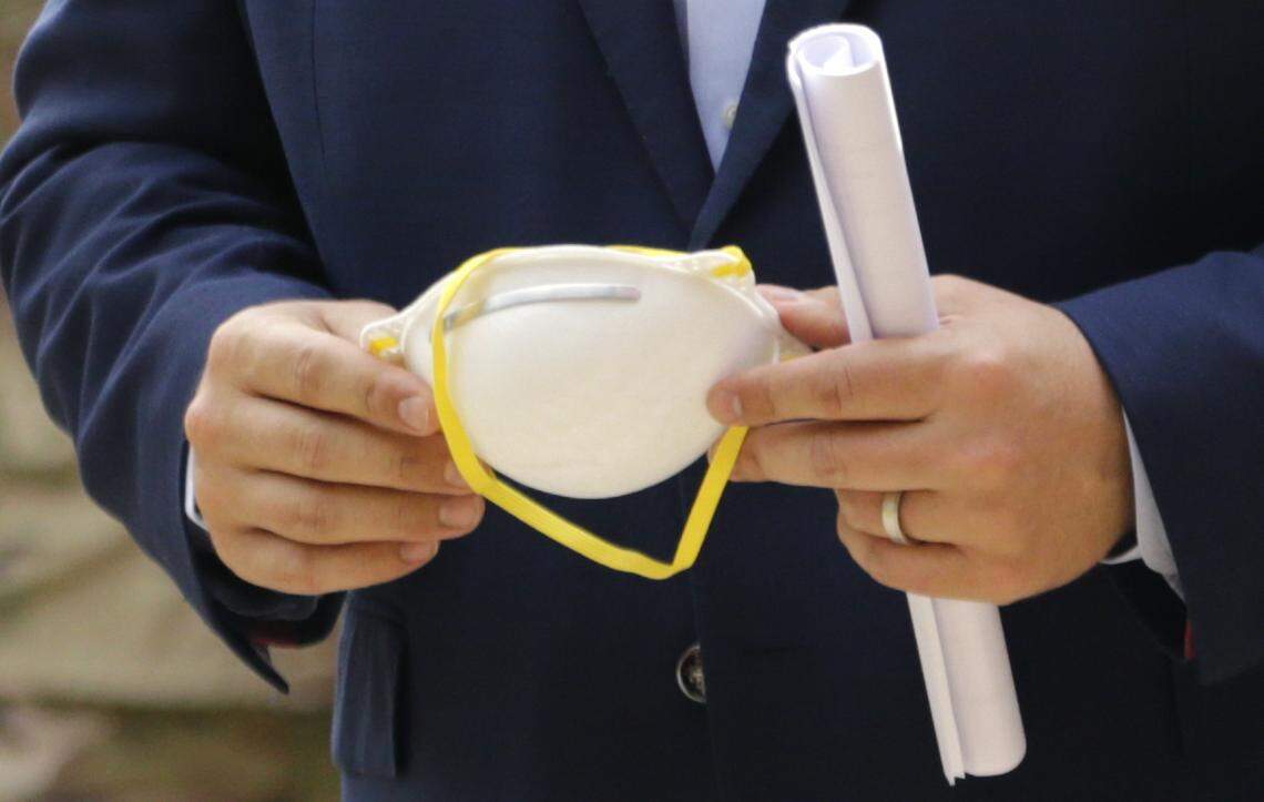 Florida Gov. Ron DeSantis holds a protective face mask during an April 17, 2020, press conference at the Urban League of Broward County to announce that Florida’s first two walk-through coronavirus testing sites will open in Broward County. They will open for testing on Saturday, April 18, in Fort Lauderdale and Pompano Beach and will start with 200 tests per day, DeSantis said.