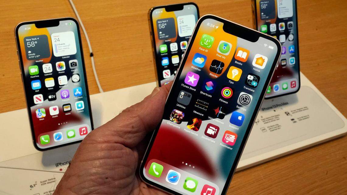 The line-up of the Apple iPhone 13 is displayed on their first day of sale, in New York, Friday, Sept. 24, 2021. iPhone 12 and 13 users can participate in the new Face ID feature.