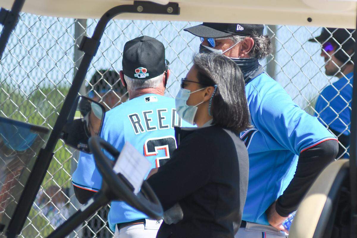 Miami Marlins general manager Kim Ng and manager Don Mattingly watch workouts on the backfields of the Roger Dean Chevrolet Stadium complex on Monday, Feb. 25, 2021.