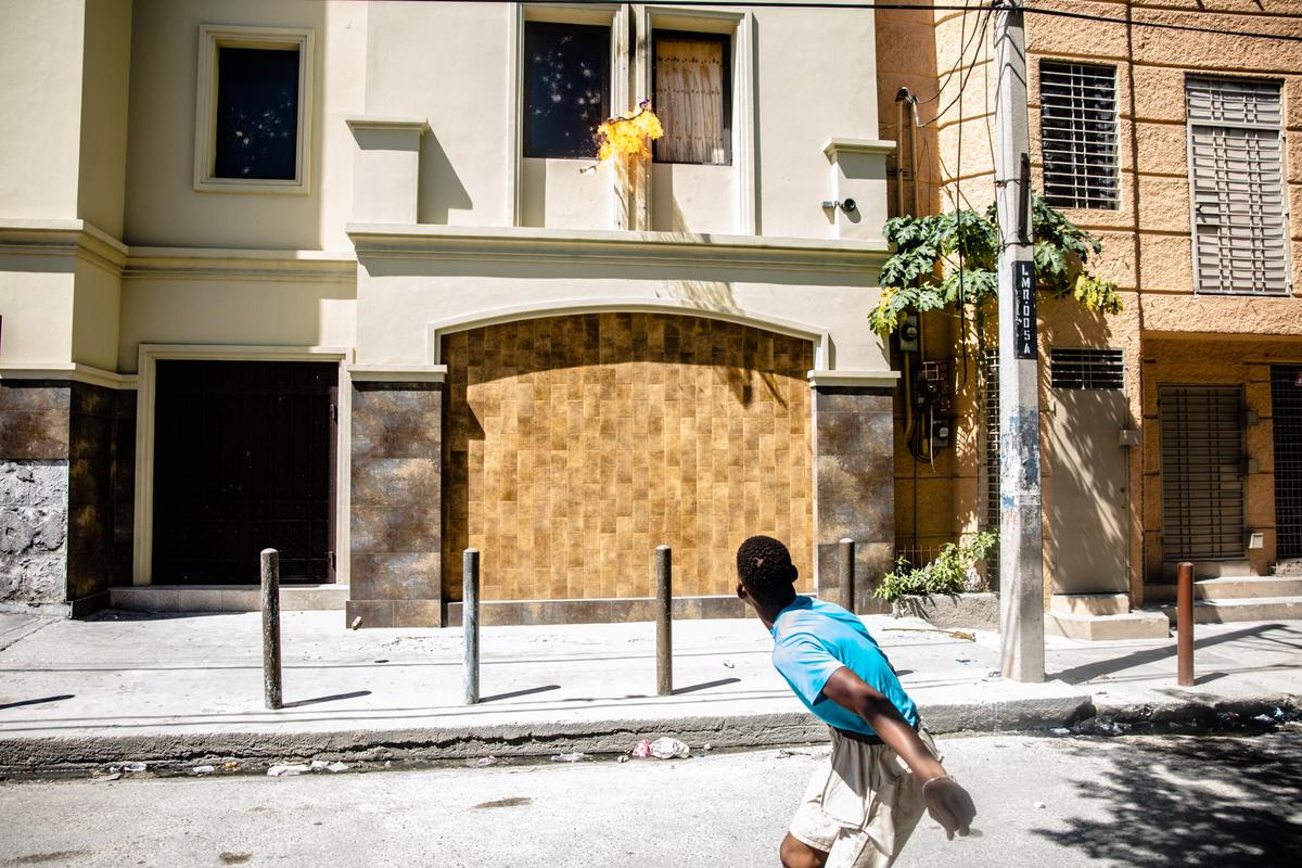 Protesters throw Molotov cocktails against the consulates of Italy and Peru during a demonstration demanding the resignation of President Jovenel Moise in the Haitian capital in Port-au-Prince on October 28, 2019.