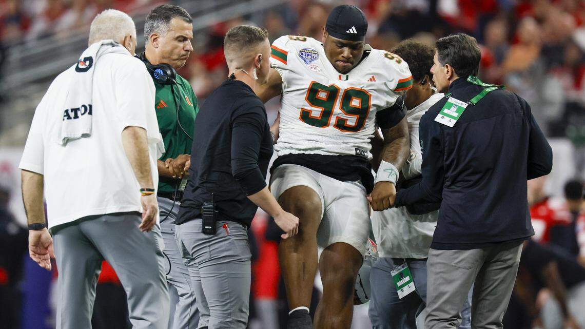 Miami Hurricanes defensive lineman Ahmad Moten Sr. (99) is assisted off the field during the second half of the College Football Playoff quarterfinal game against the Ohio State Buckeyes in the Cotton Bowl at AT&T Stadium in Arlington, Texas on Wednesday, December 31, 2025.