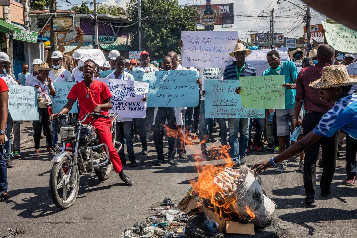 Protesters, medical professionals, and political opponents demand the resignation of President Jovenel Moise during a demonstration in the Haitian capital in Port-au-Prince on Oct. 30, 2019.