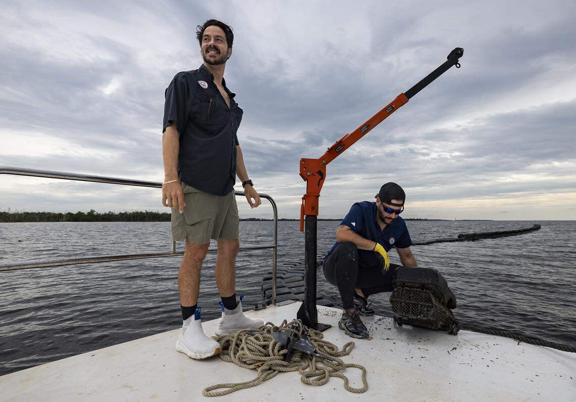 Everglades Oysters co-founder Fabio Galarce, left, and Josue Rivas check on their oyster farm operating off Panther Key, near Cape Romano, in the Ten Thousand Islands on Wednesday, Sept. 17, 2025, in Florida.