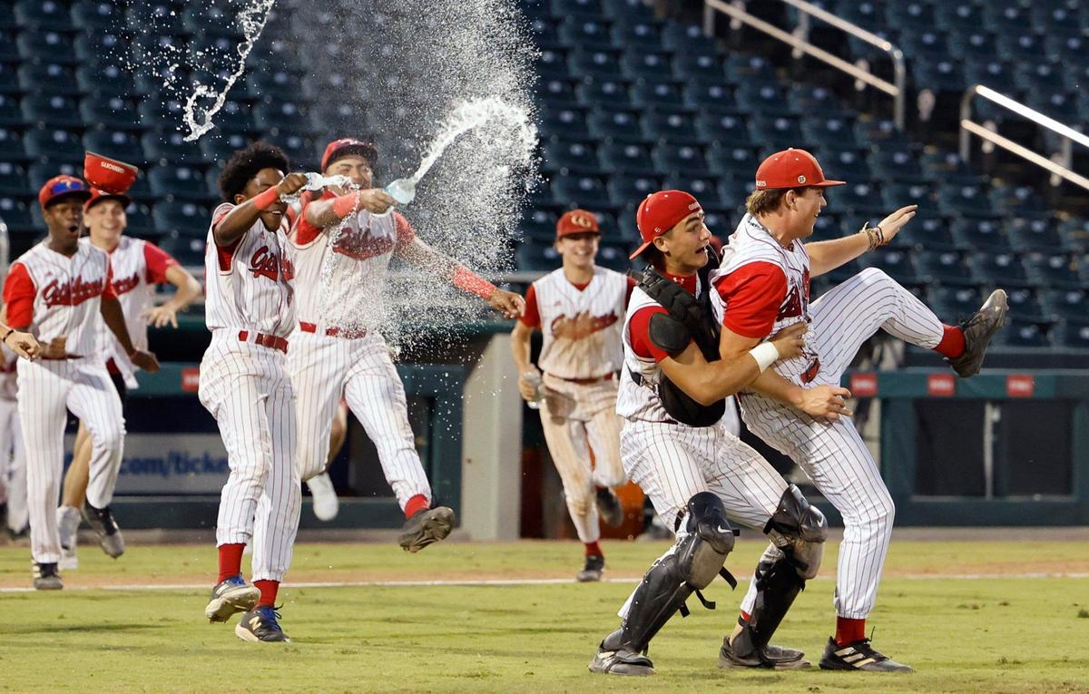 Cardinal Gibbons Chiefs catcher Eddie Marshall (5) lifts pitcher Brenden Trujillo (25) as they celebrate the win against the South Walton Seahawks for the FHSAA Baseball Class 4A State Final at Hammond Stadium in Fort Myers, Florida on Wednesday, May 22, 2024.