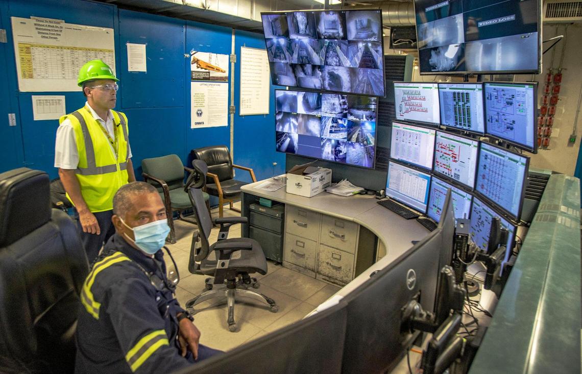 Michael J. Fernandez, left, director of Miami-Dade Solid Waste Management, talks to operator Harvey Harris in the control room at the Miami-Dade Resources Recovery Facility-Covanta Energy incinerator plant at 6990 NW 97th Ave. in Doral, on Friday April 14, 2022.