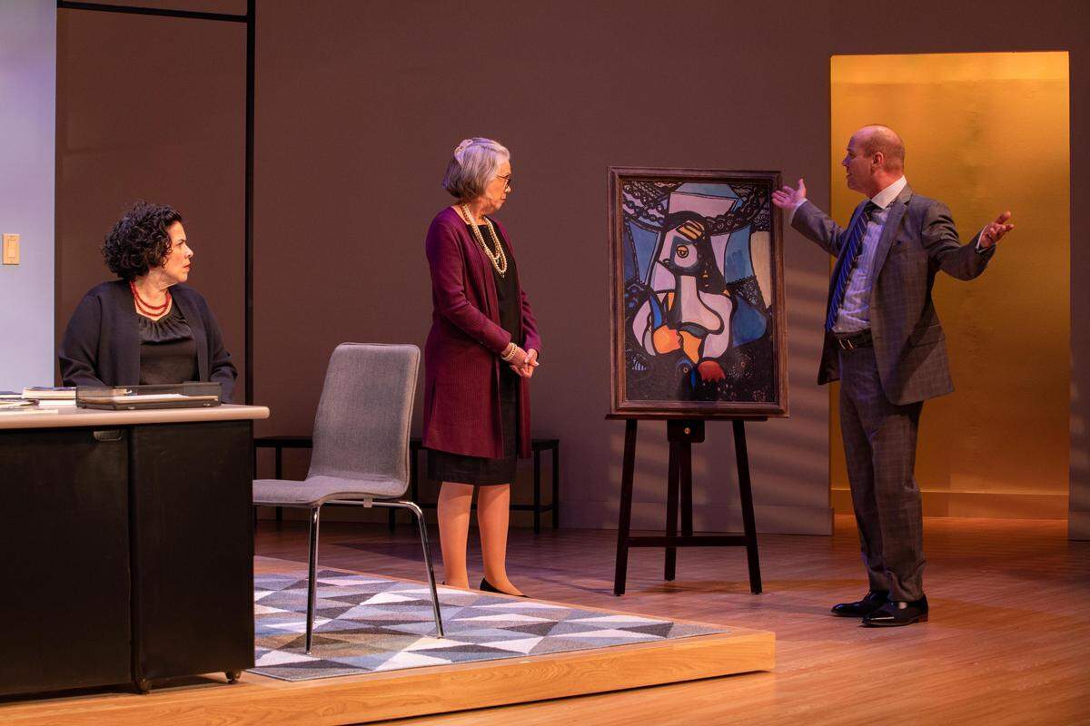 As Carmen Pelaez’s Carmen looks on, Carole Monferdini and Tom Wahl consider the authenticity of an Amelia Pelaez painting in Miami New Drama’s world premiere of ‘Fake.’