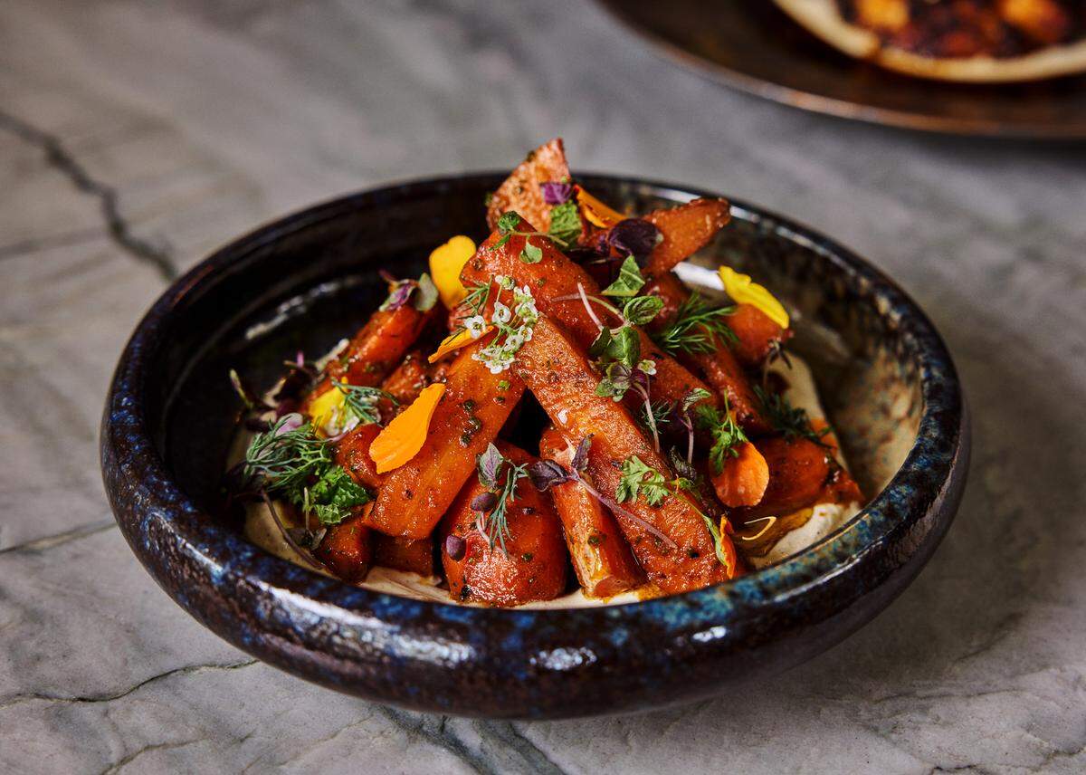 Charred jerk carrots with pickled tomatoes, spiced yogurt and herbs at Salt and Ash at Hawks Cay Resort.