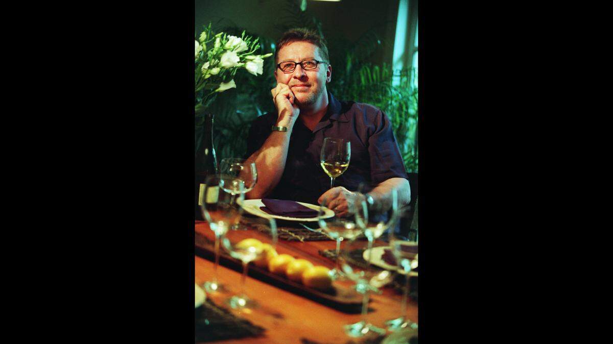 Chef Robbin Haas sits in his Coconut Grove home where he had set the table for friends in this file photo from May 16, 2001. Haas was a professional chef at “Baleen” restaurant on Grove Isle.