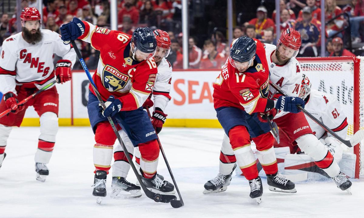 Florida Panthers center Aleksander Barkov (16) and Carolina Hurricanes center Sebastian Aho (20) compete for the puck in the first period of Game 3 during the Eastern Conference final of the NHL Stanley Cup playoffs at Amerant Bank Arena on Saturday, May 24, 2025, in Sunrise, Fla.
