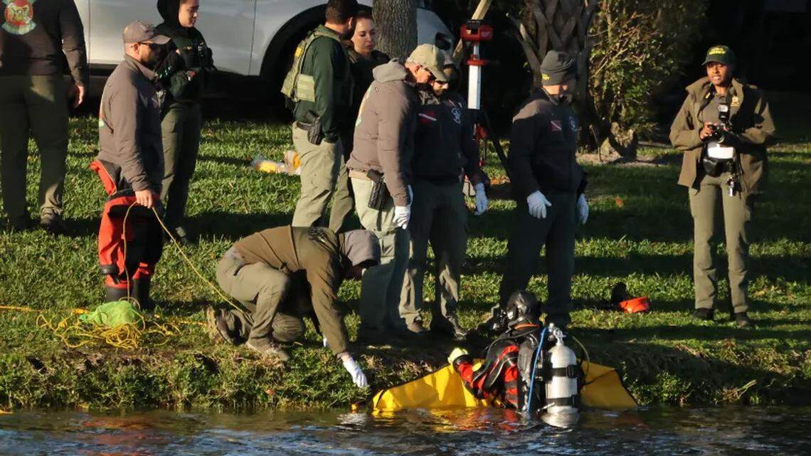 Broward Sheriff’s Office divers recover a body from a car that plunged into a lake on Tuesday in Deerfield Beach.