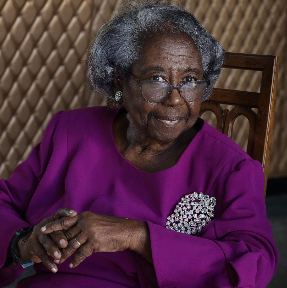 Former director Enid C. Pinkney is photographed in the grand lobby of the Hampton House.
