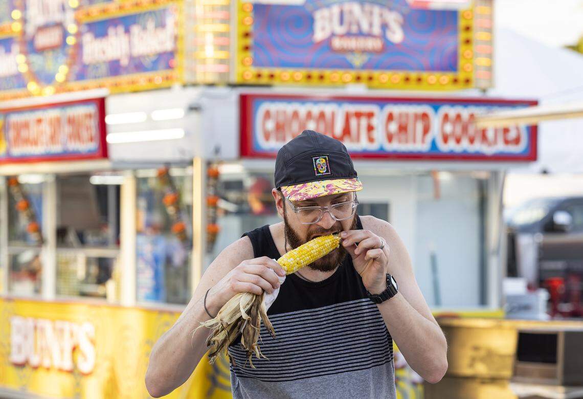 Gabriel Delgado bites into a corn on the cob during the opening day of the 74th annual Miami-Dade County Youth Fair on Thursday, March 12, 2026, in Miami, Fla.
