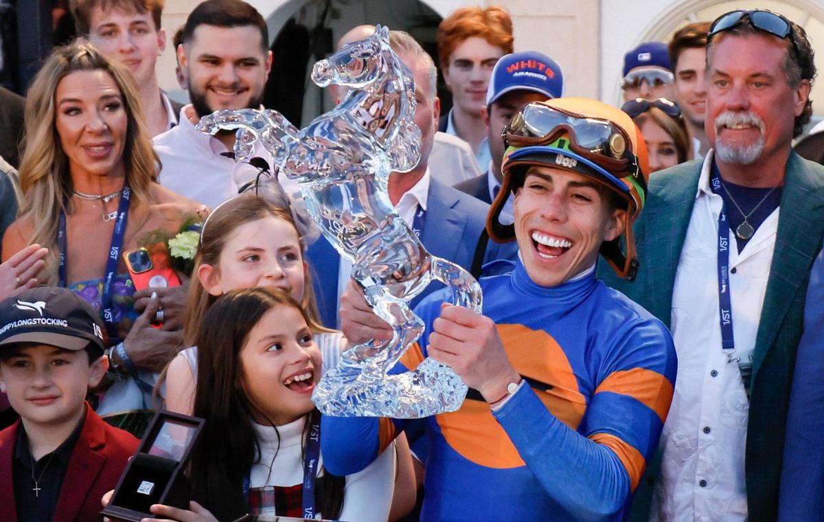 Jockey Irad Ortiz, Jr., riding White Abarrio #4, lifts the trophy as he celebrates winning the 9th Running of the Pegasus World Cup Invitational at Gulfstream Park in Hallandale Beach, Florida on Saturday, January 25, 2025.