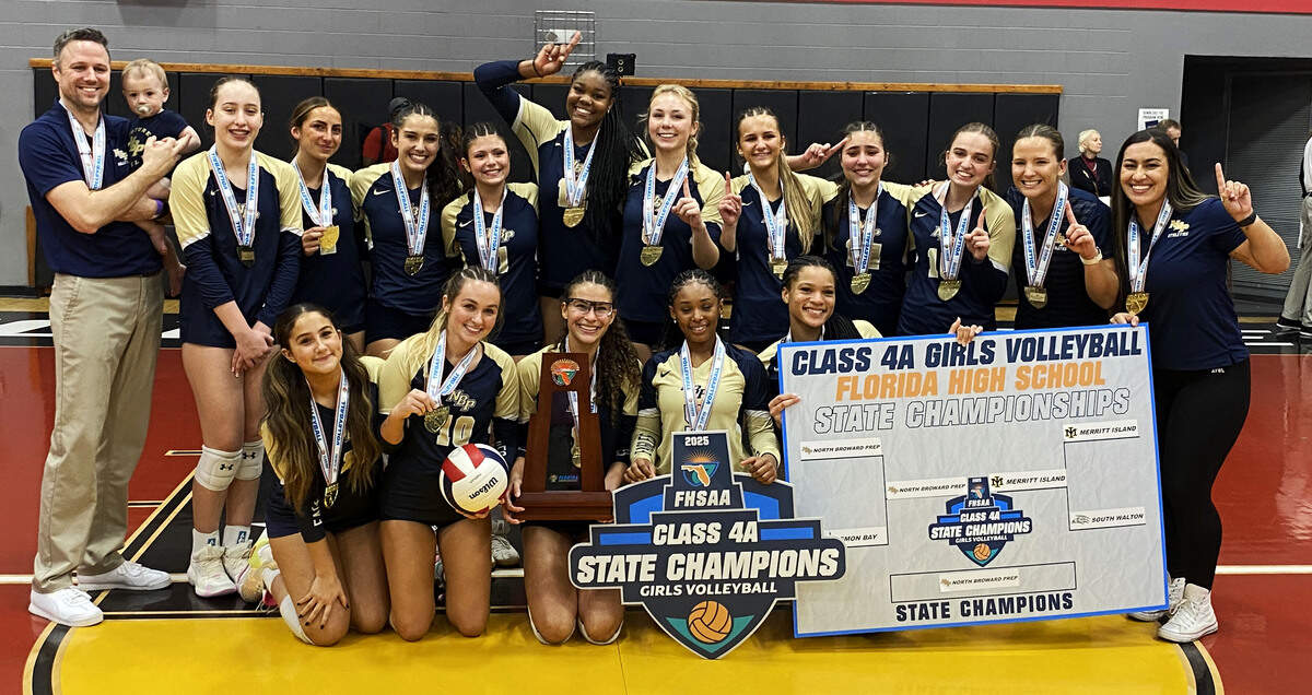 North Broward Prep players and coaches gather with the state championship trophy after winning the FHSAA Class 4A girls volleyball title against Merritt Island on Saturday at Polk State College in Winter Haven.