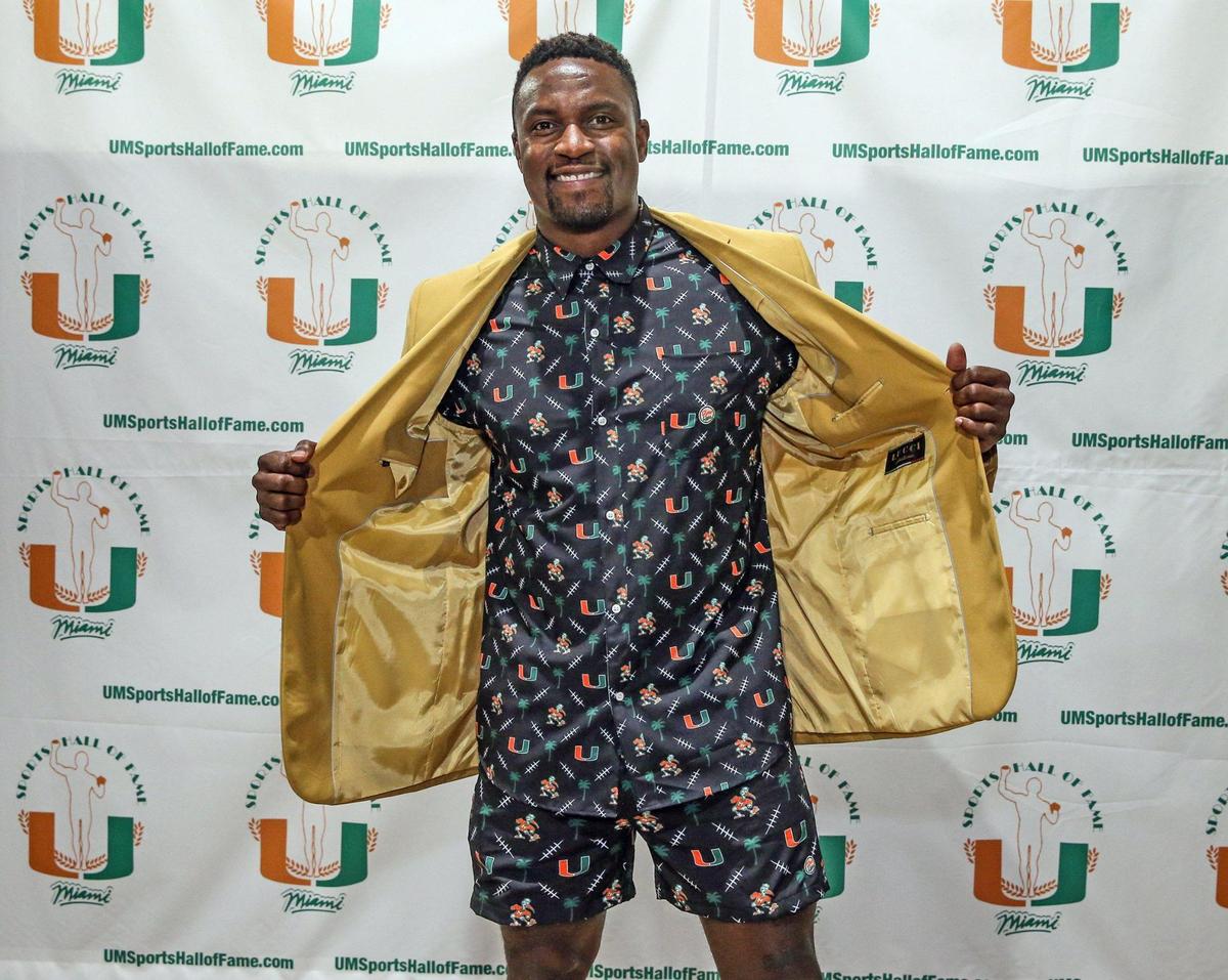 Football inductee DJ Williams flashes a piece from his Dyme Lyfe line of clothing during the University of Miami Sports Hall of Fame Induction Banquet at the Doubletree by Hilton Miami Airport ConventionCenter in Miami, Florida on Thursday, April 21, 2022.