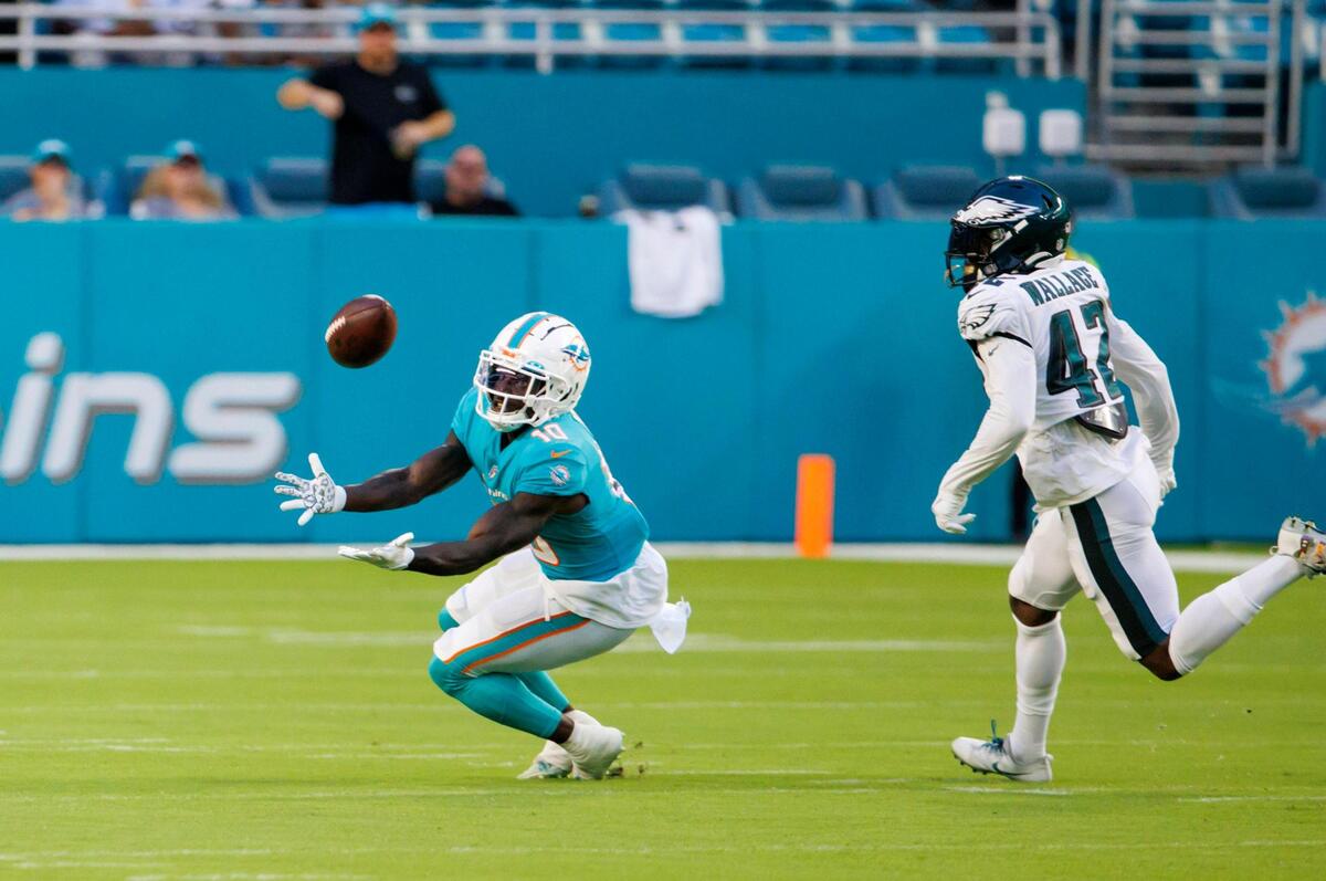 Miami Dolphins wide receiver Tyreek Hill (10) catches a pass against Philadelphia Eagles safety K’Von Wallace (42) during first quarter of an NFL preseason football game at Hard Rock Stadium on Saturday, August 27, 2022 in Miami Gardens, Florida.