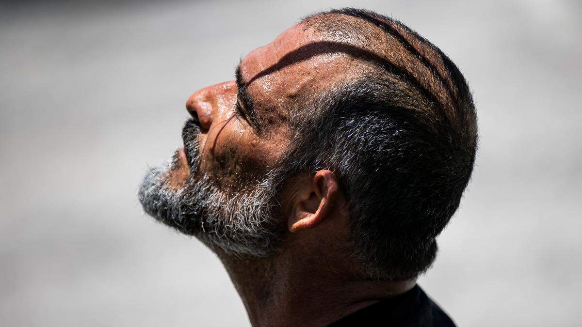 Beads of sweat gather on Orlando Castro, 53, as he takes a moment to rest after riding his bike at Haulover Skateboard Park on Wednesday, June 14, 2023, in Miami Beach, Fla. Miami-Dade County issued a heat advisory for residents after the National Weather Service estimated the heat index would reach between 105 and 108 degrees.