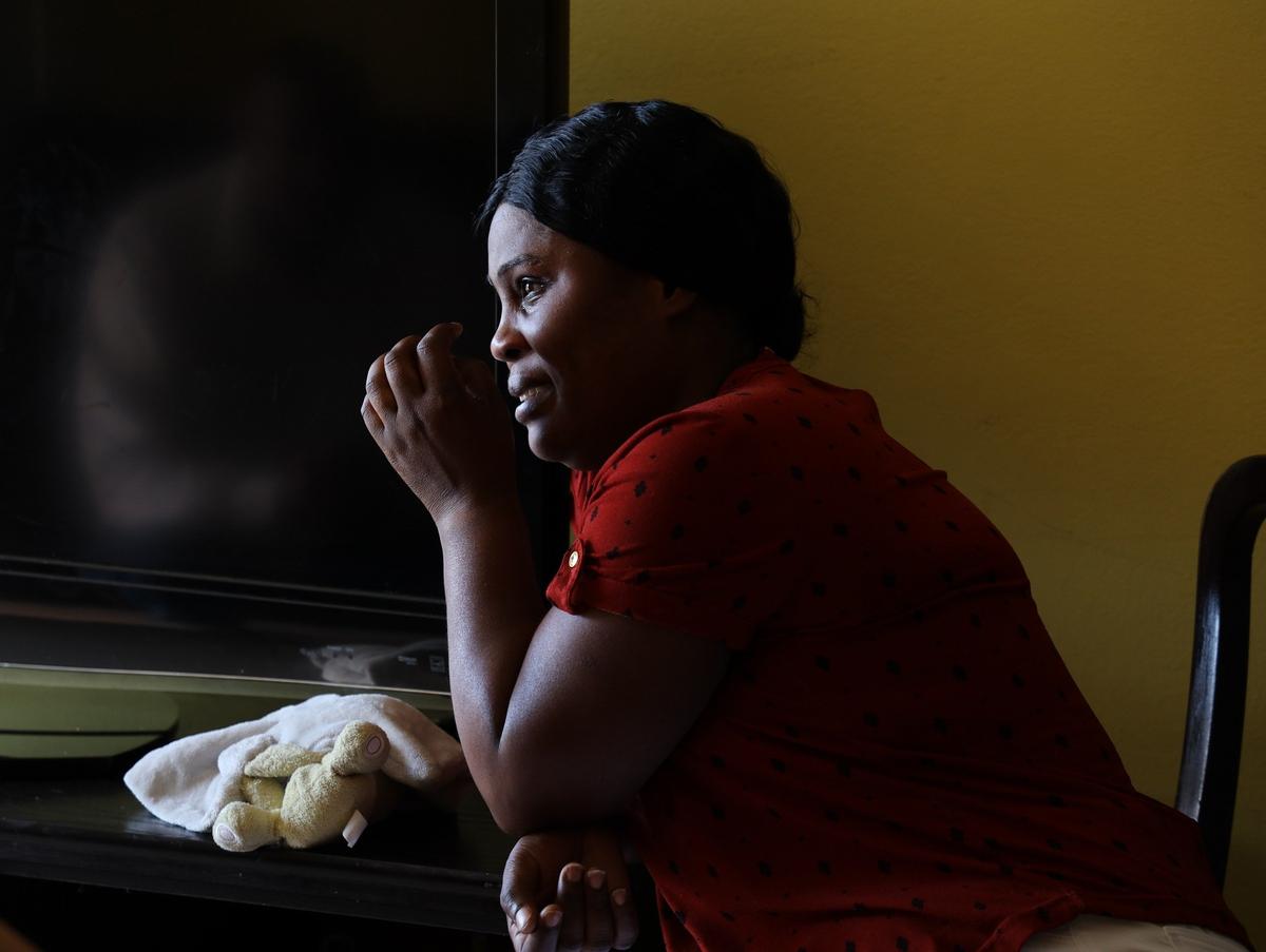 Andrea Campbell-Connolly, 39, fights back tears as she listens to her husband Dana Connolly, 61, a veteran battling stage four cancer, retell his life setbacks.