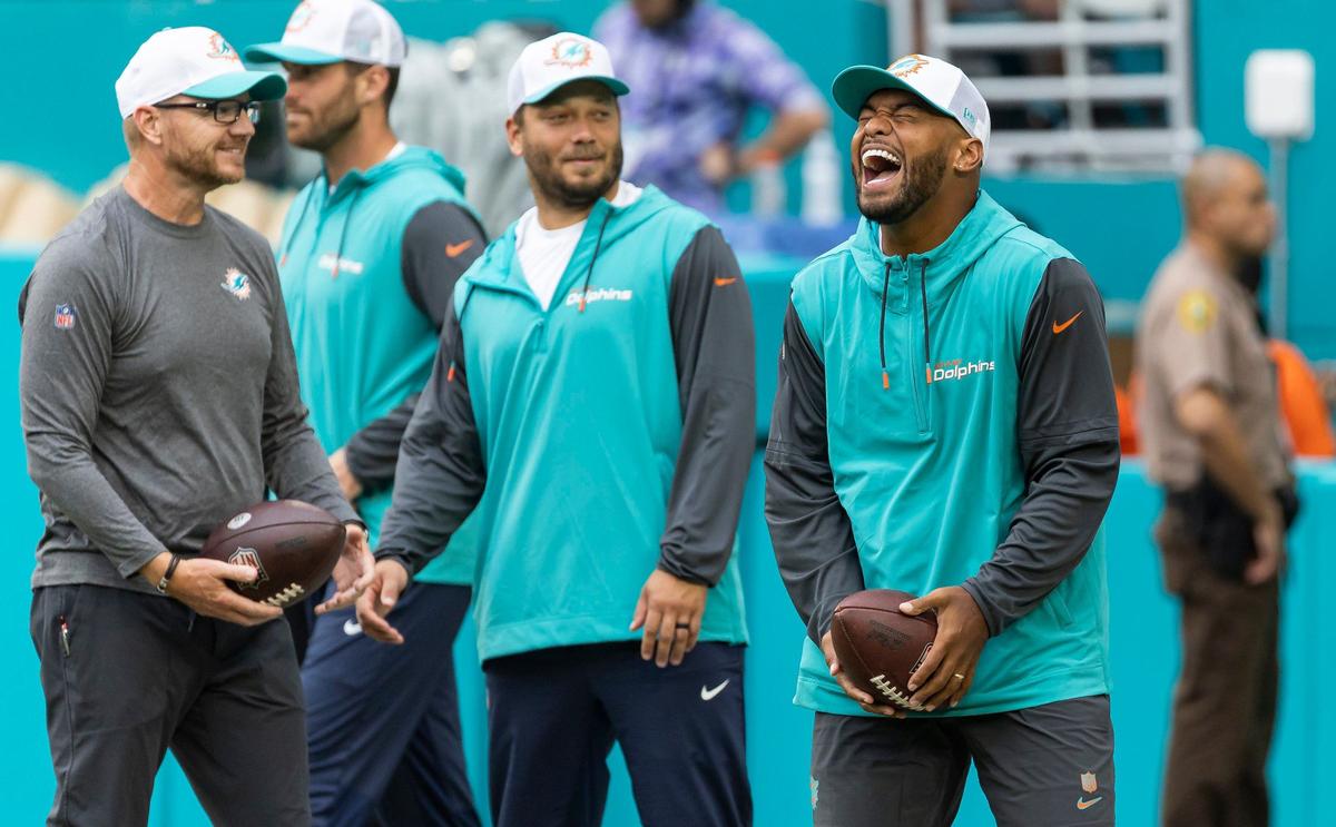 Miami Dolphins quarterback Tua Tagovailoa (1) reacts as his teammates warm up before their NFL pre-season football game against the Atlanta Falcons at Hard Rock Stadium on Friday, Aug. 9, 2024, in Miami Gardens, Fla.